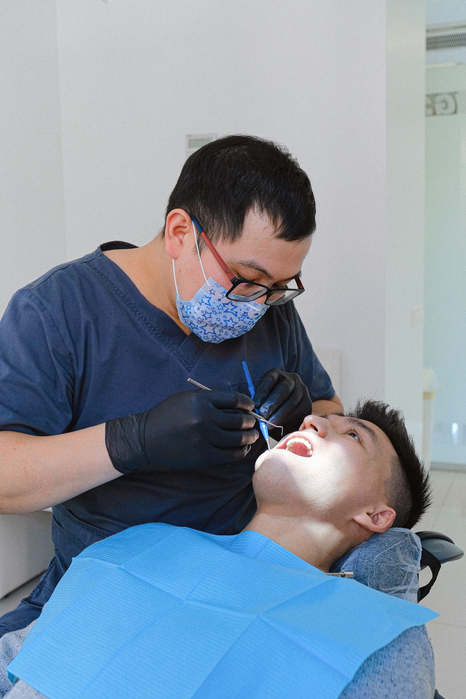 A dental professional conducting a routine examination